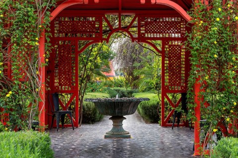 Marrakesh, Morocco, 24 March, 2024: fountain and red gazebo in the heart of the Anima Garden in