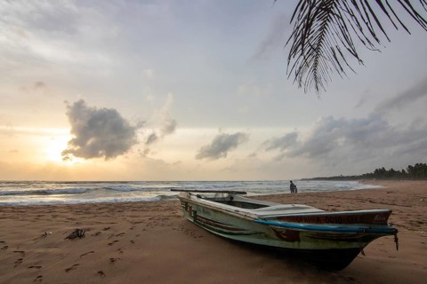 Landscape by the sea and sandy beach. A boat lies in the sand and adds a special touch to the