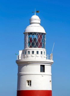 Red and white striped lighthouse at Europa Point, Gibraltar, British territory in southern Spain,
