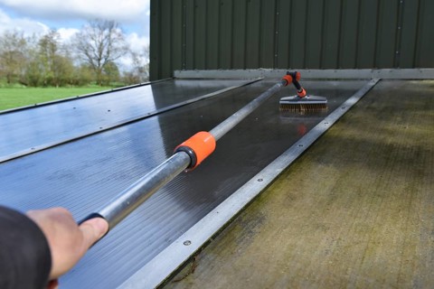 Clean patio roof with telescopic pole and brush