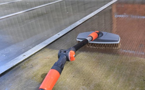 Clean patio roof with telescopic pole and brush