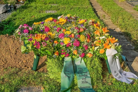 Flowers on a fresh grave in the cemetery