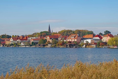 Picturesque town view at the lake with red roofs and nature, island town, Malchow,