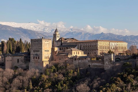 Alhambra on the Sabikah hill, Moorish city castle, Nasrid palaces, behind the snow-covered Sierra