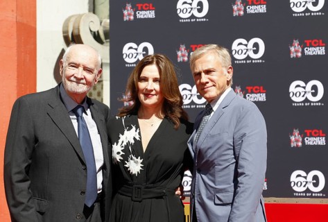 Christoph Waltz supports producers Michael G. Wilson and Barbara Broccoli at their handprints