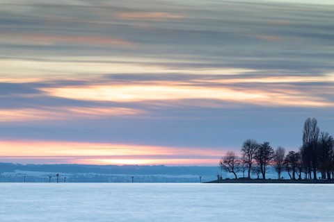 A picturesque sunset over a lake with trees and a colourful sky, harbour, Immenstaad, Lake