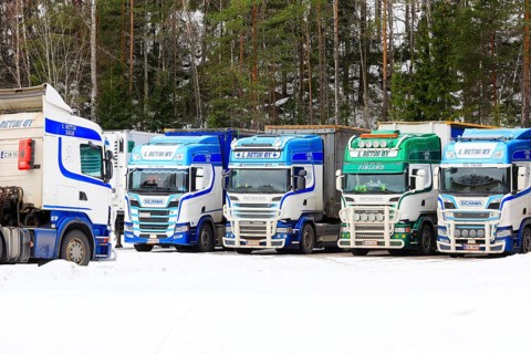 Beautifully customized Scania trucks L. Retva Oy parked at depot on a Sunday morning in winter.
