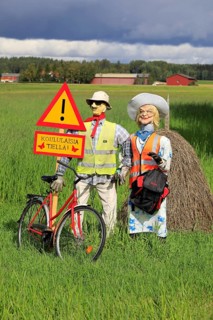 Funny arrangement of an couple with safety vests on alerts motorists of the Hiiden koulu school