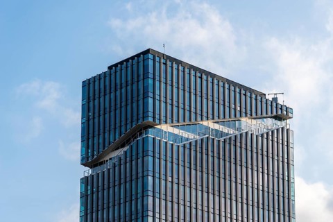 Amsterdam, Netherlands, May 7, 2022: Low angle view of futuristic architecture skyscraper against