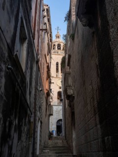 Narrow alley in the old town and church tower, Old Town of Korcula, Dalmatia, Croatia, Europe