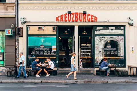 Berlin, Germany, July 29, 2019: Trendy restaurant with tables on sidewalk in Kreuzberg quarter.
