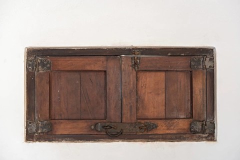 An old wooden shutter in a white wall, Mexico, Central America
