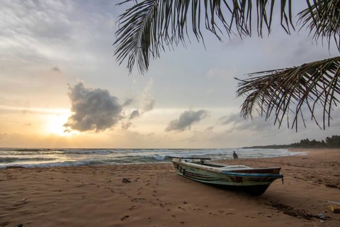 Landscape by the sea and sandy beach. A boat lies in the sand and adds a special touch to the