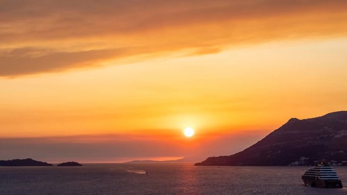 Cloudy atmosphere at sunset by the sea, view from the bell tower, cruise ship near Korcula, Korcula