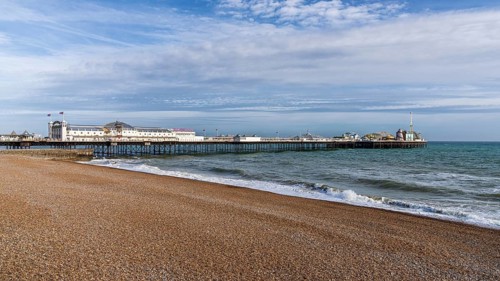 Brighton, East Sussex, England, UK, May 10, 2022: The beach and the Palace Pier