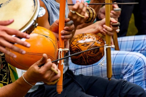 Several afro Brazilian percussion musical instruments during a capoeira performance in the streets