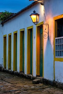 Dusk in the historic city of Paraty with colonial houses and facades illuminated by lanterns