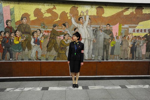 09.08.2012, Pyongyang, North Korea, Asia, A platform supervisor stands in front of a huge mosaic