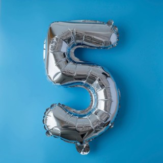 5 five metallic balloon isolated on blue background. Greeting card silver foil balloon number Happy