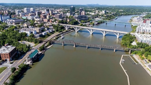 An aerial view of Knoxville, Tennessee reveals a vibrant cityscape with a mix of historic and