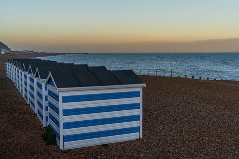 Hastings, East Sussex, England, UK, May 11, 2022: Evening mood on the beach with some beach huts