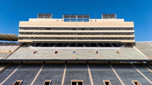 An aerial view of Neyland Stadium reveals a massive, iconic structure nestled by the Tennessee