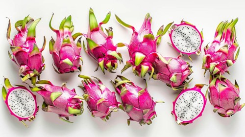 Several whole and sliced dragon fruits exposing white flesh with seeds on a white surface, AI