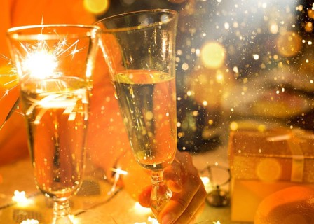 Sparklers in a glass of champagne, transparent glass with wine and splashes. New Year, festive