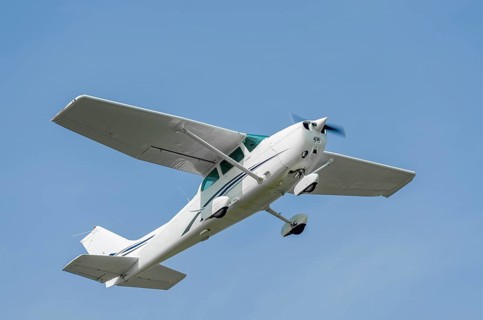 Single-engine sport airplane in a clear blue sky
