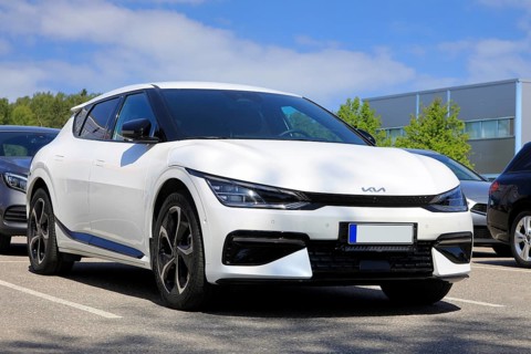 White Kia EV6 fully electric crossover car parked at the new car dealership. Salo, Finland. June