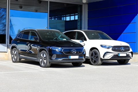 Black Mercedes-Benz EQA 250 battery electric SUV year 2023 and new white Mercedes-Benz 4matic SUV