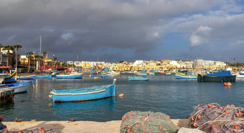 Marsaxlokk, Malta, 22 December, 2023: colorful fishing boats in the harbor of Marsaxlokk in