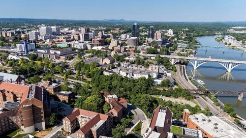 An aerial view of Knoxville, Tennessee reveals a vibrant cityscape with a mix of historic and
