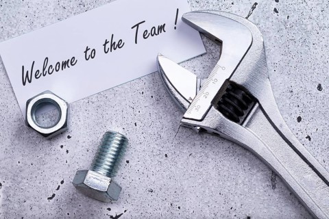 The photo shows a label with the inscription 'welcome to our team' with a spanner and screw on a