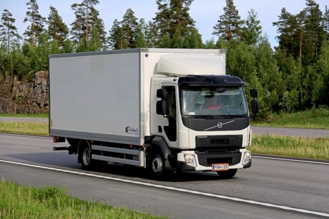 PAIMIO, FINLAND, JUNE 3, 2016: White Volvo FE delivery truck transports goods along motorway at
