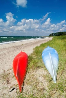 Red and blue Canoe on the beach near the Danish village Saltofte on the isle of Funen