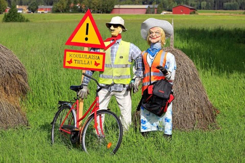 Funny arrangement of an couple with safety vests on alerts motorists of the Hiiden koulu school