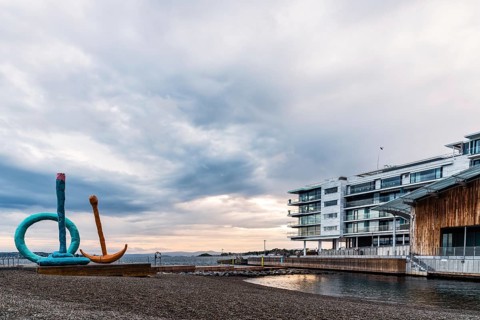Oslo, Norway, August 11, 2019: Scenic view of sunset on Tjuvholmen quarter a new modern urban