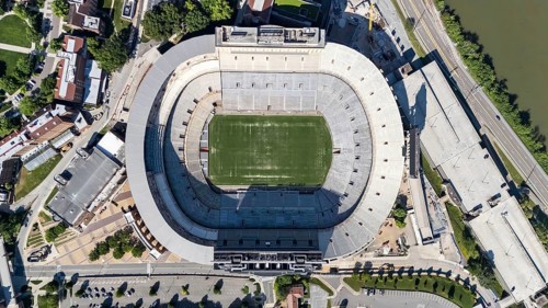An aerial view of Neyland Stadium reveals a massive, iconic structure nestled by the Tennessee