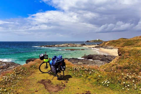E-bike on the South West Coast Path, coastline with Godrevy Island and lighthouse, landscape