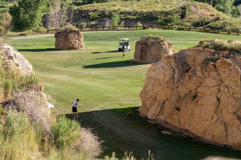 Golden, Colorado, The Fossil Trace Golf Course. Golfers play near footprints of dinosaurs and