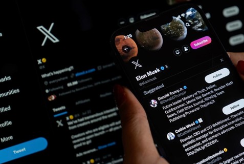 In this photo illustration a person browsing Elon musk X account, formerly Twitter, on an iPhone,