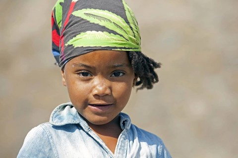 Close up portrait of Creole girl wearing headscarf on the island of Santiago, Cape Verde, Cabo