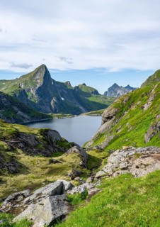 Lake Tennesvatnet and mountain landscape with rocky pointed peaks, Hermannsdalstinden mountain in
