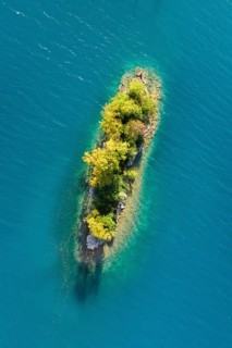 Bird's eye view of the chive island in the turquoise waters of Lake Walen in the canton of St.