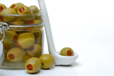 Green olive stuffed with pieces of paprika