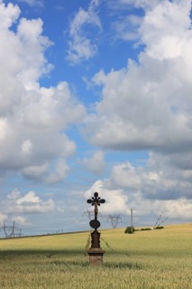 Field cross in a wheat field, near Dukovany, Czech Republic, Grain field with a lonely field cross,