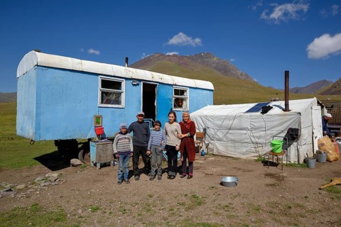 Shepherd family in front of their caravan on their summer pasture, West Karakol Valley, Tien Shan