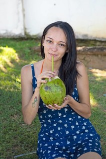 Brazilian woman, 26, drinking from coconut, Salvador, Bahia State, Brazil, South America