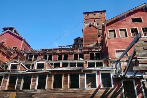 Old industrial ruins on the hillside, copper mining, red wooden buildings, ghost town, Unesco World